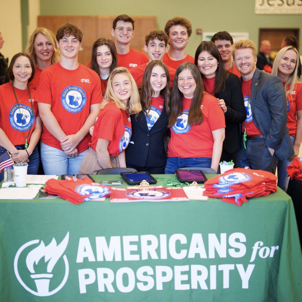 Group of young people gathered at an Americans for Prosperity booth during an event